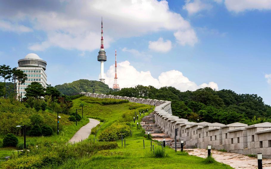 There is a high building beside N Seoul Tower. 