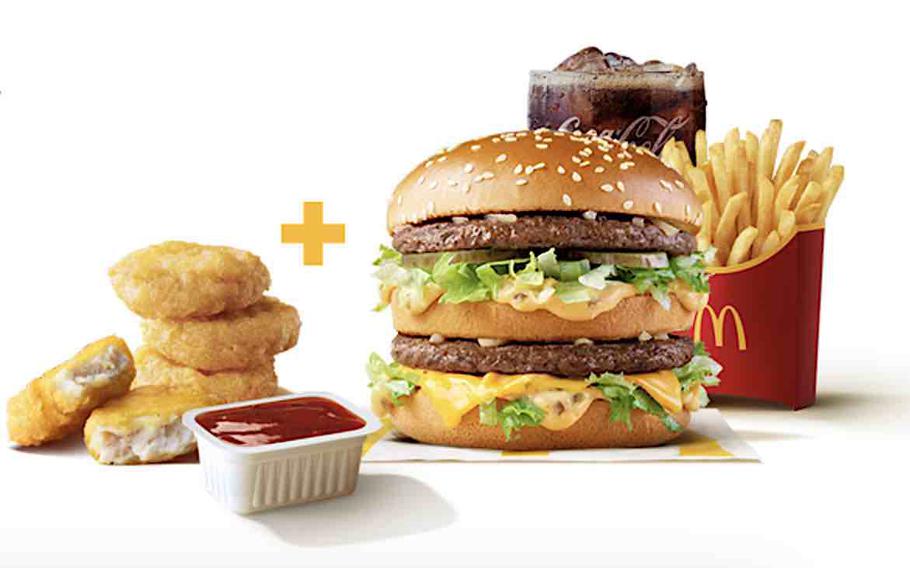 A burger, french fries, a glass of coke, and 4 McNuggets with ketchup.
