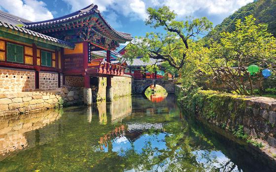 A river or a pond in front of the temple.