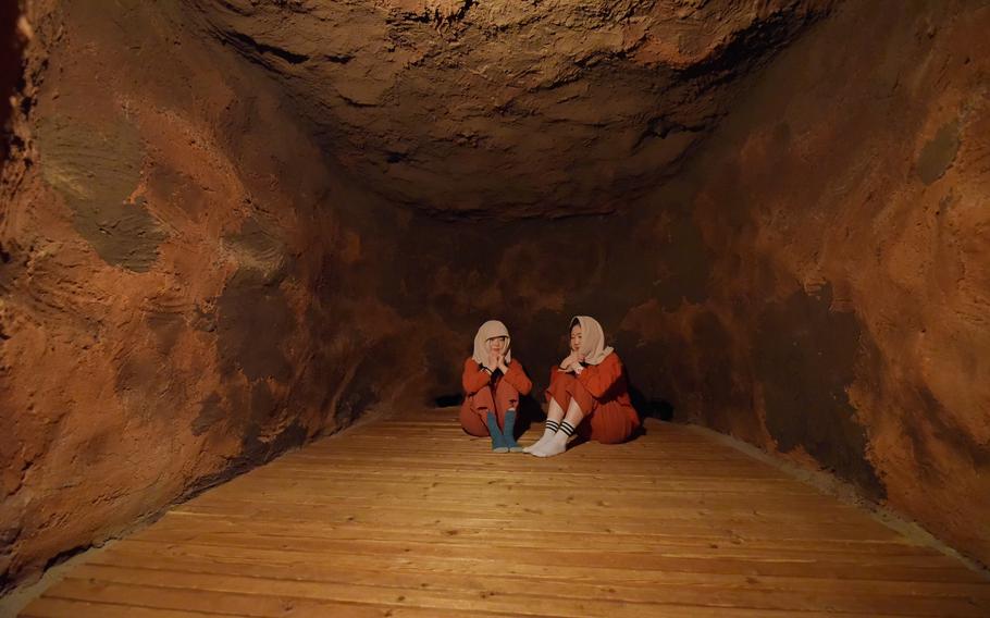 two people sitting on the floor of the dry and heated room.