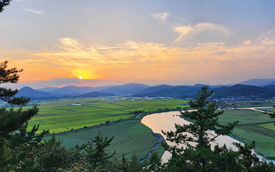 View from the observatory. Mountains, rice paddies, and a river can be seen.