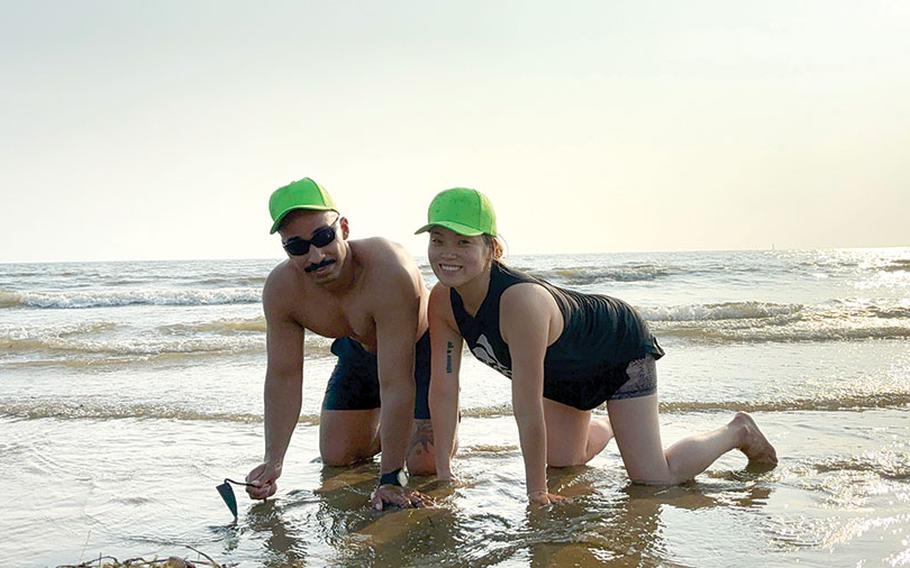 Mr. and Mrs. Lewis with matching hats enjoying a clam catching adventure on the beach.