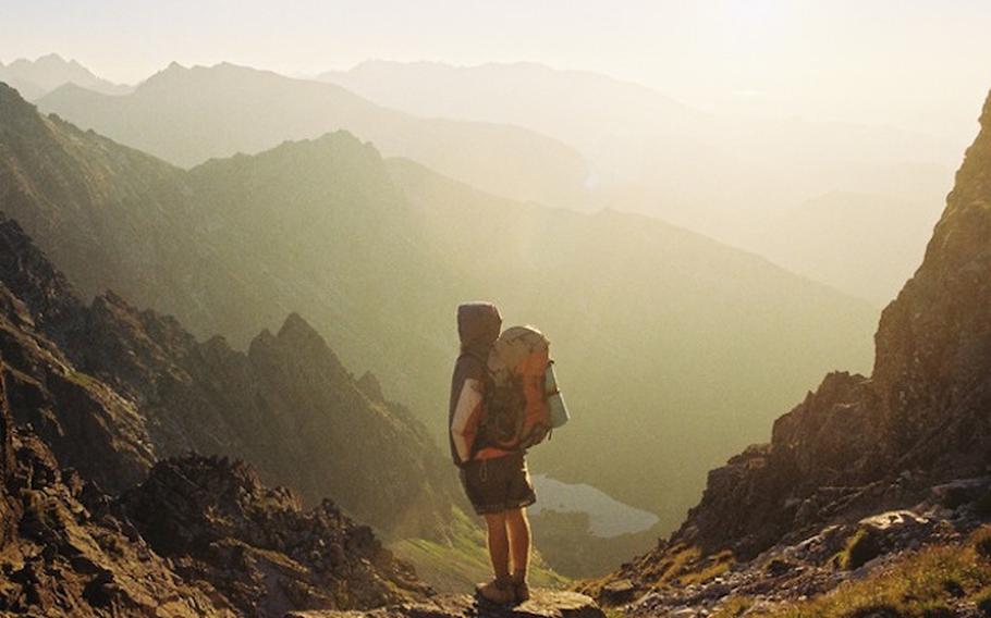 a person with a backpack on their back on a trail.