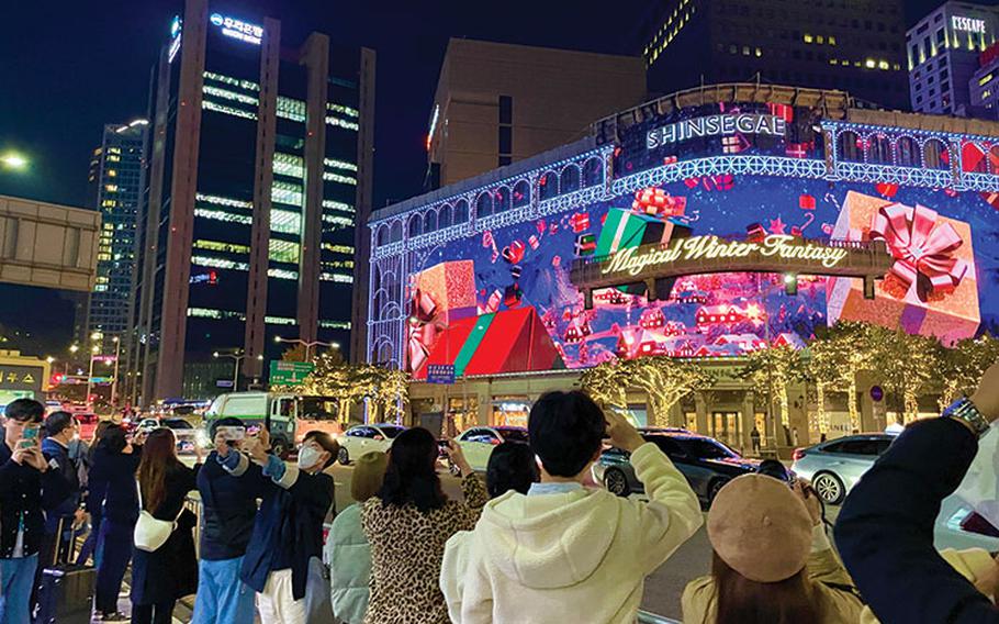 people are taking photos of illuminated building.