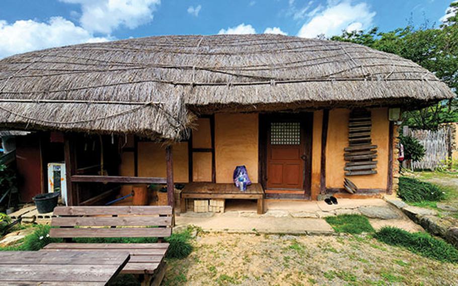 One -story house with a straw-thatched roof.