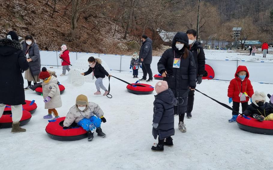 kids are enjoying themselves with something like flotation rings.