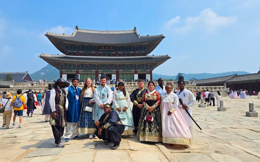 Participant pose for a photo in front of the palace.