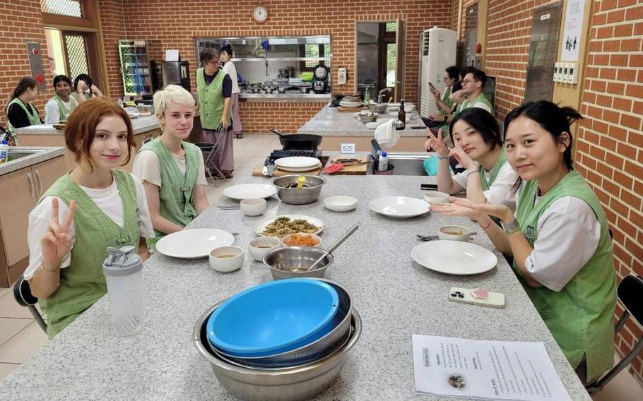 Attendees at a cooking class pose for a photo.