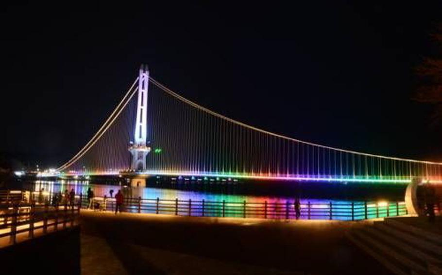 Yedangho Suspension Bridge and fountains light up at night.