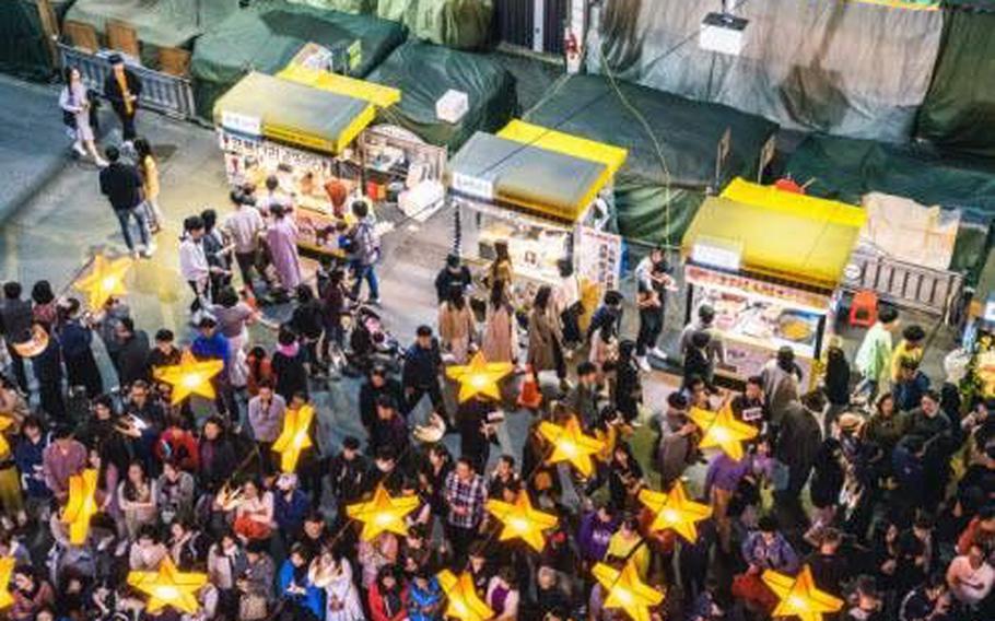 Birds-eye view of Seomun Night Market. The street is crowded with people.