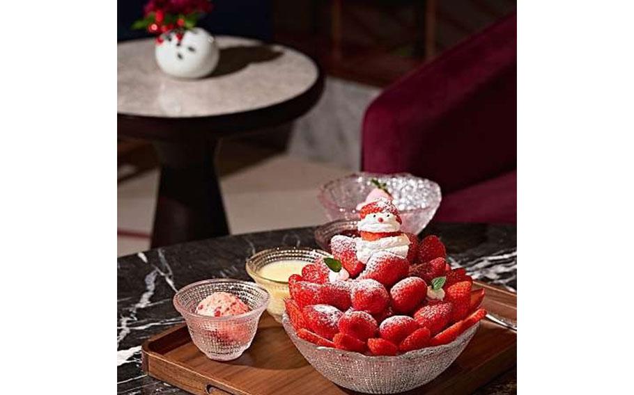 fresh strawberries are on a glass bowl. Also, strawberry ice cream is in another glass bowl.