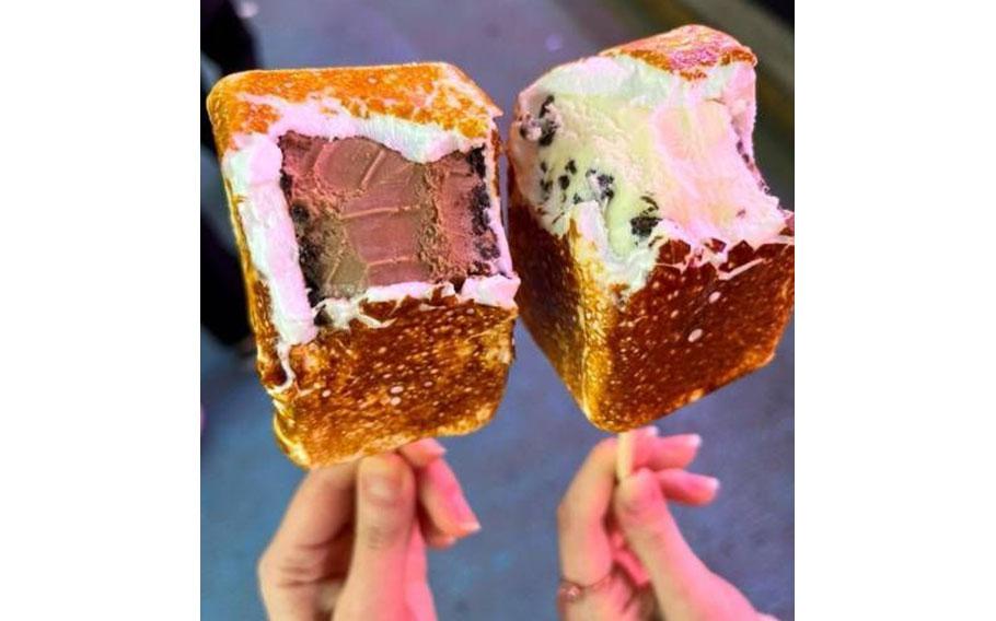 Two people have a Grilled Ice Cream on one of their hands.