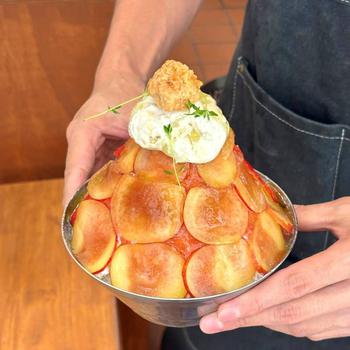 A person holds Plum bingsu with both hands.