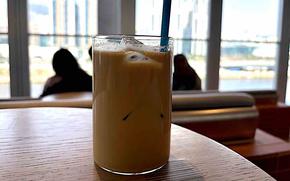 a glass oc iced coffee on the table.