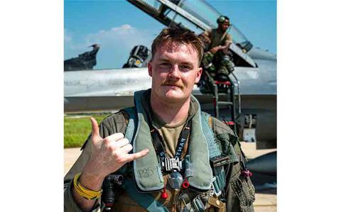 Photo Of U.S. Air Force Capt. Griffin Line, 35th Fighter Squadron pilot, flashes the 35th FS “Push it Up” sign during exercise Ulchi Freedom Shield 25 at Kunsan Air Base.