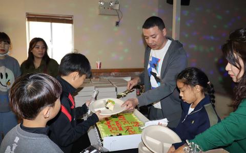 Photo Of Col. Henry Brown, commander, 403rd Army Field Support Brigade, serves cake at the community relations event hosted by the Powerhouse Brigade in support of the United States Forces Korea Good Neighbor Program.