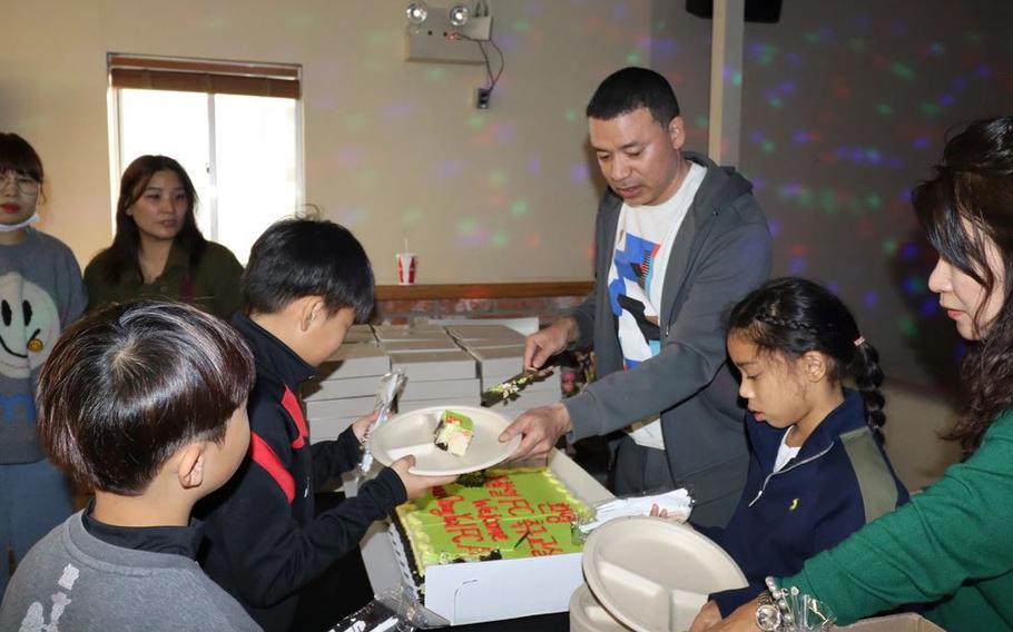 Col. Henry Brown, commander, 403rd Army Field Support Brigade, serves cake at the community relations event hosted by the Powerhouse Brigade in support of the United States Forces Korea Good Neighbor Program.