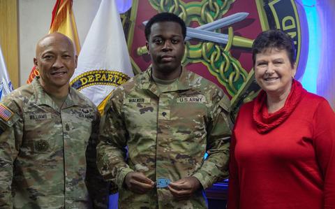 Photo Of U.S. Army Spc. Bryson Walker, assigned to Headquarters and Headquarters Company, U.S. Army Garrison Yongsan-Casey, receives a coin from Ms. Brenda McCullough, director of Installation Management Command-Pacific, during a visit to Camp Casey, South Korea, Feb. 20, 2025.