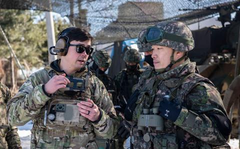 Photo Of U.S. Air Force Staff Sgt. Kai Wakeland, 607th Air Support Operations Group joint terminal attack controller, left, briefs Republic of Korea Army Lt. Col. Daesoo Kang, 112th Mechanized Infantry Battalion commander, about air asset positioning during a joint exercise in Hongcheon, Republic of Korea.