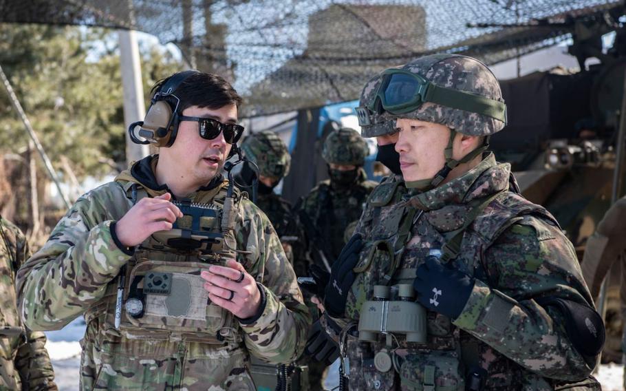 U.S. Air Force Staff Sgt. Kai Wakeland, 607th Air Support Operations Group joint terminal attack controller, left, briefs Republic of Korea Army Lt. Col. Daesoo Kang, 112th Mechanized Infantry Battalion commander, about air asset positioning during a joint exercise in Hongcheon, Republic of Korea.