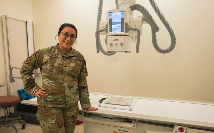 U.S. Air Force Staff Sgt. Kimberly Gracia, 8th Health Care Operations Squadron diagnostics & therapeutics non-commissioned officer in charge, poses for a photo next to an x-ray machine at Kunsan Air Base, Republic of Korea, Dec. 18, 2024. 