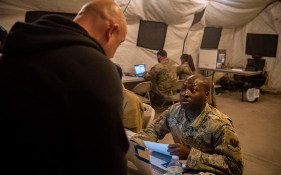 U.S. Air Force Tech. Sgt. Francis Atchoe, 51st Force Support Squadron augmentee right, in-processes an augmentee for exercise Freedom Shield 25 at Osan Air Base, Republic of Korea, March 1, 2025.