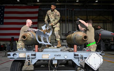 Photo Of Airmen prepare munitions for loading during the 2024 3rd Quarter Dedicated Crew Chief and Load Crew Competition at Kunsan Air Base.