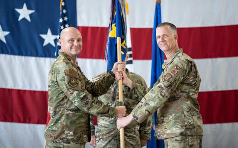 Photo Of U.S. Air Force Col. Jeff Elliott, left, 51st Civil Engineering Group commander, passes the guidon to Lt. Col. Kirk Hull, incoming 51st Civil Engineer Squadron commander, during a Change of Command ceremony at Osan Air Base.