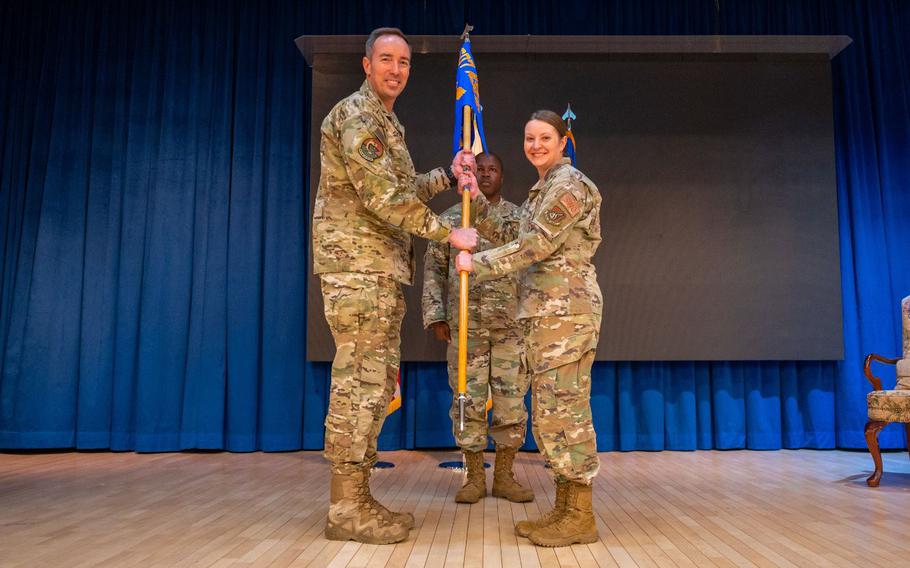 Col. Scott Morgan, 607th Air Support Operations Group commander, left, presents Lt. Col. Nessa Hock, 607th Combat Weather Squadron (CWS) commander, the guidon during the Assumption of Command ceremony at Osan Air Base, Republic of Korea, June 7, 2022. The 607th CWS is responsible for all planning and coordination efforts necessary to provide weather support to the United States Army during armistice conditions in the Republic of Korea. (U.S. Air Force photo by Tech. Sgt. Zachariah Lopez)