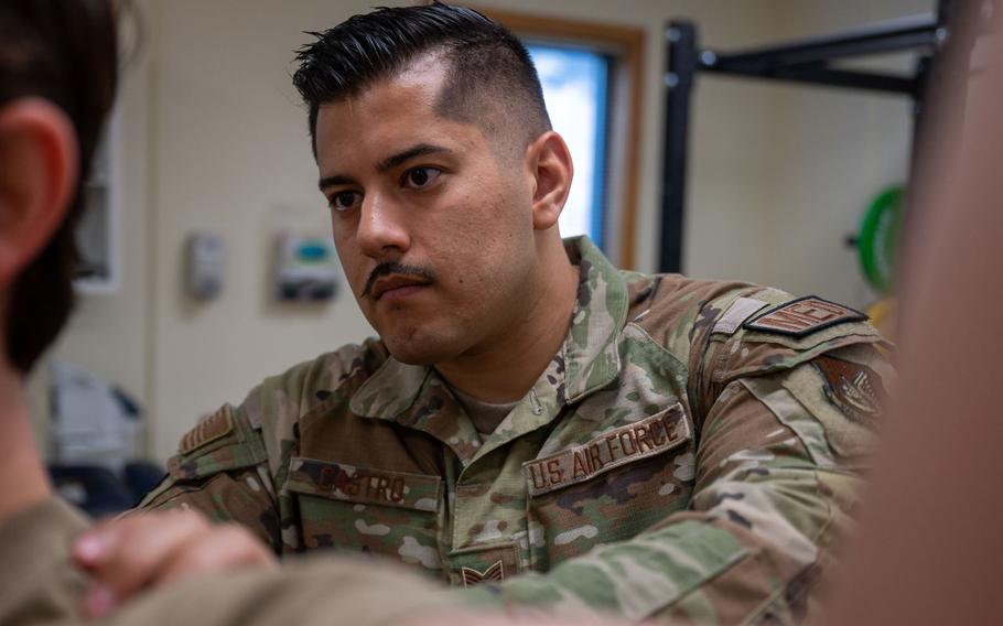 SSgt Alejandro Castro, 8th Medical Group physical therapy non-commissioned officer in charge, shows the location his patient should focus when performing an exercise during a therapy session at Kunsan Air Base, Republic of Korea, July 7, 2023. Castro was selected for demonstrating exceptional leadership in leading a two man team during an emergency and neutralizing chemical contaminants for four patients. (U.S. Air Force photo by Staff Sgt. Samuel Earick)