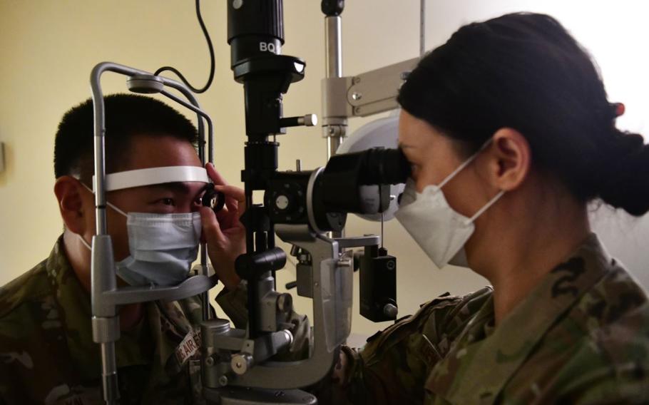 Capt. Anna Liew-Ramos, 51st Medical Group optometry officer in charge performs an eye exam on Tech. Sgt. Jonghwan Kim, 51st MDG human performance flight chief at Kunsan Air Base, Republic of Korea, Aug. 11, 2022. The Osan Air Base, ROK, optometry office routinely to Kunsan Air Base, ROK, to provide care to Wolf Pack Airmen. (U.S. Air Force Photo by Staff Sgt. Isaiah J. Soliz)