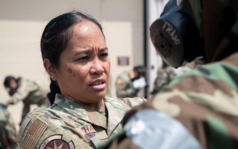 Lt. Col. Elisa Hammer, 8th Operational Medical Readiness Squadron commander, performs a buddy check during a training event at Kunsan Air Base, Republic of Korea, Aug. 17, 2022. Training reinforces Airmen readiness, strengthens capabilities and ensures the Wolf Pack has the ability to defend the base, accept follow-on forces and take the fight north. (U.S. Air Force photo by Staff. Sgt Sadie Colbert)