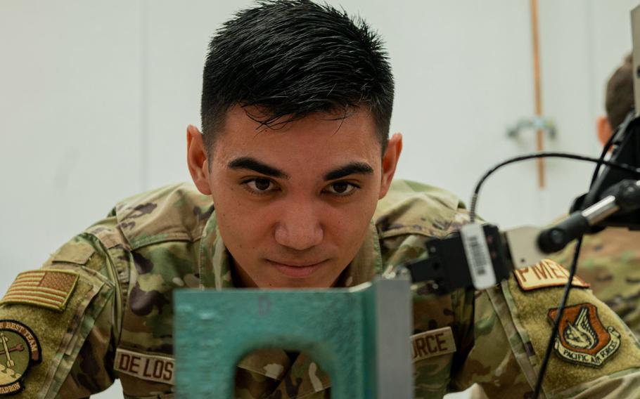 U.S. Air Force Senior Airman Bryant De Los Reyes, 51st Maintenance Squadron precision measurement equipment laboratory logistics technician, compares the parallelism of an angle iron at Osan Air Base, Republic of Korea, Dec. 15, 2023. PMEL plays a fundamental role in keeping Osan’s tools safe, efficient, accurate and reliable. (U.S. Air Force Senior Airman Kaitlin Castillo)