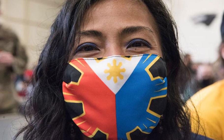 Senior Master Sgt. Mary Anne Chambers, 8th Comptroller Squadron superintendent, shows off her Filipino flag mask during the Diversity and Inclusion Day at Kunsan Air Base, Republic of Korea April 12, 2021. Participants enjoyed cultural performances and food, as well as discussions and activities related to the day's theme, 'Heritage through Diversity.' (U.S. Air Force photo by Tech. Sgt. Will Bracy)