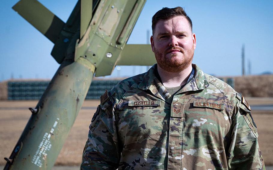 Staff Sgt. Login Costello, 8th Maintenance Squadron quality assurance evaluator, stands near a munitions static display at Kunsan Air Base, Republic of Korea, December 7, 2023. Costello was a driving force in establishing Kunsan AB’s first-ever siren & broadcast warning drill. (U.S. Air Force Photo by Staff Sgt. Jovan Banks)