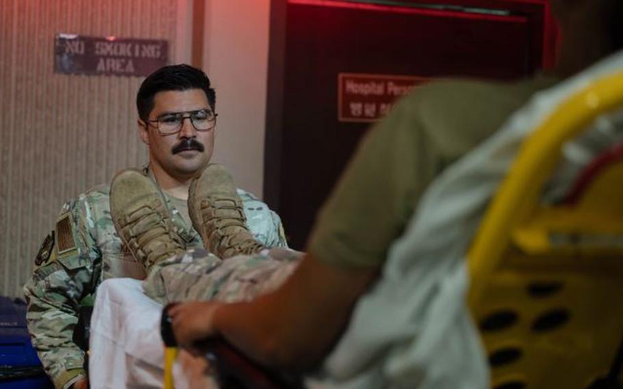 U.S. Air Force Tech. Sgt. Stephen Kreidler, 51st Operational Medical Readiness Squadron independent duty medical technician, transports a patient off an ambulance at Osan Air Base, Republic of Korea, Aug. 13, 2024.