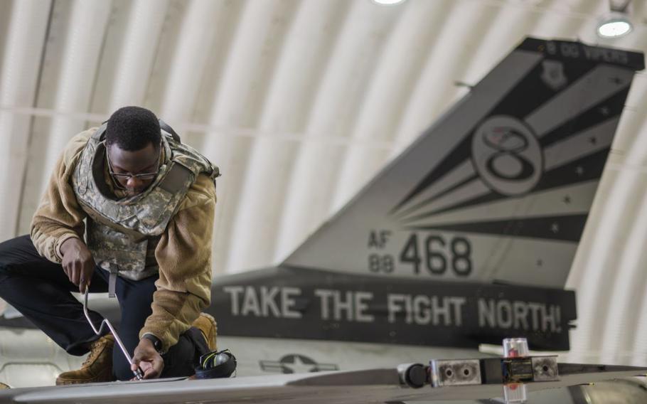 Senior Airman Elvis Atieno, 80th Fighter Generation Squadron dedicated crew chief, performs maintenance on an F-16 Fighting Falcon during Beverly Sentinel 24-1 at Kunsan Air Base, Republic of Korea, March 27, 2024.