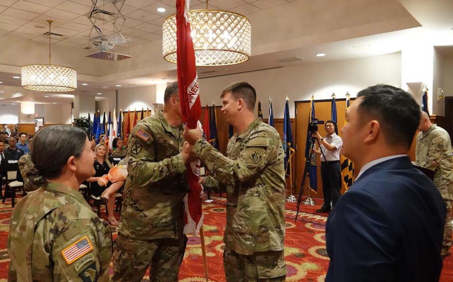 Brig. Gen. Joseph C. “Clete” Goetz II, U.S. Army Corps of Engineers (USACE) – Pacific Ocean Division (POD) commanding general, passes the district colors to Col. Jeremiah J. Willis, the incoming commander of the USACE Far East District (FED), during a change of command ceremony held at River Bend Golf Course, USAG Humphreys, Republic of Korea, August 21, 2024.