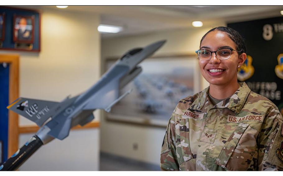 Senior Airman Jasmyn Farmer, 8th Operations Group resource advisor, poses for a photo after winning the Pride of the Pack award, Kunsan Air Base, Republic of Korea, July 27, 2023. Farmer was selected for her meticulous attention to detail and hard work while providing financial guidance and mentorship to four commanders, three squadrons and 225 personnel. (U.S. Air Force photo by Senior Airman Karla Parra)