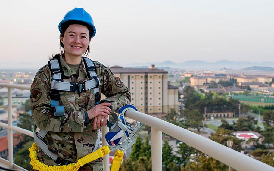 First Lt. Abby Fenn stands on the water tower at Kunsan Air Base, Republic of Korea, May 4, 2022. Fenn arrived at Kunsan after requesting to serve in the Republic of Korea, aiming to learn more about her familial heritage. (U.S. Air Force photo by Tech. Sgt. James Cason)