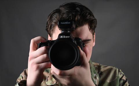 Photo Of Senior Airman James Johnson, 8th Fighter Wing public affairs journeyman, takes a photo at Kunsan Air Base.