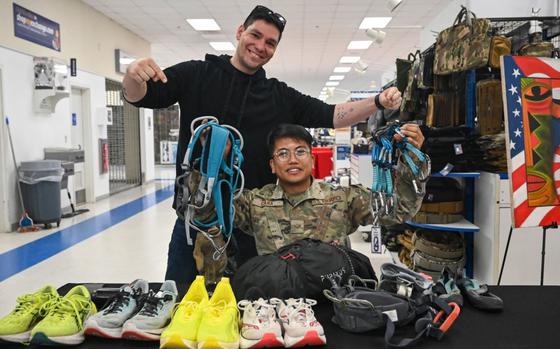 Photo Of U.S. Air Force Staff Sgt. Max Lavigne, left, 8th Civil Engineer Squadron operations management craftsman, and Senior Airman Louver Cara, 8th Logistics Readiness Squadron vehicle maintenance journeyman, pose with rock climbing gear at Kunsan Air Base.