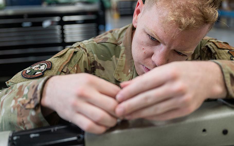 Staff Sgt. Nathan Gooch, 8th Operations Support Squadron Aircrew Flight Equipment main hub non-commissioned officer in charge, prepares a sewing machine for use at Kunsan Air Base, Republic of Korea, June 8, 2023. Pride of the Pack is a wing driven program where nominees are submitted by squadron senior enlisted leaders then compete against other nominees across the installation. (U.S. Air Force Photo by Staff Sgt. Samuel Earick)