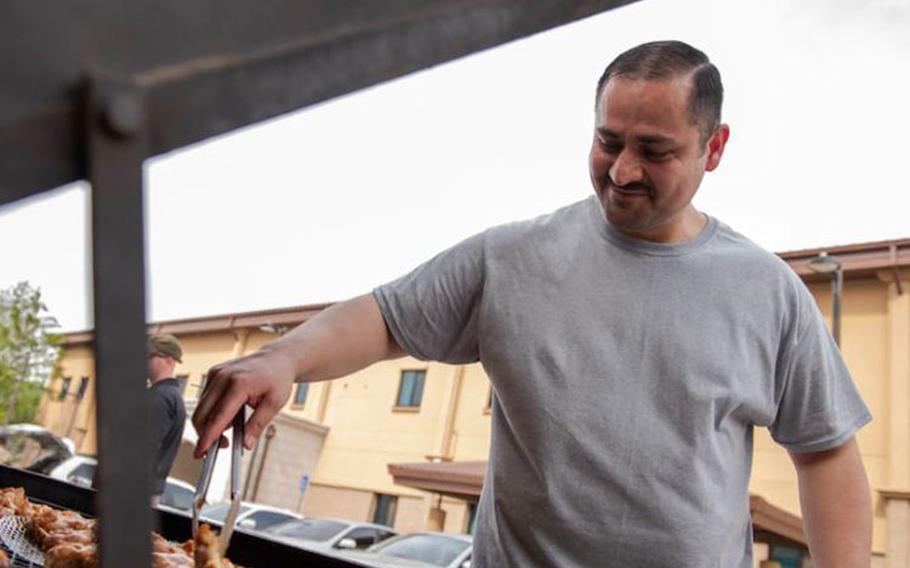 Master Sgt. Alejandrino Herrera, 51st Security Forces Squadron commander support staff superintendent, barbeques food for the Police Week Morale Cookout at Osan Air Base, Republic of Korea, May 13, 2021. The cookout ended a week-full of different activities that allowed SFS Defender’s to build morale and honor the fallen. (U.S. Air Force photo by Staff Sgt. Douglas Lorance)