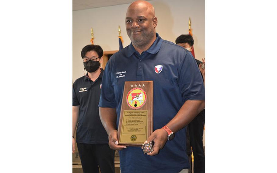 Carlos Hill, chief, Maintenance Division, Army Field Support Battalion–Korea, displays the Fiscal Year 2022 Army Award for Maintenance Excellence plaque following the presentation ceremony at Camp Humphreys, South Korea, Dec. 8, 2022. (Photo Credit: Galen Putnam, 403rd AFSB Public Affairs)