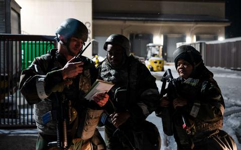 Photo Of U.S. Air Force Staff Sgt. Tucker Looney, left, Senior Master Sgt. Christopher Johnson, center, and Staff Sgt. Tanya Muirhead, 51st Civil Engineer Squadron damage assessment repair team, report a hazard.