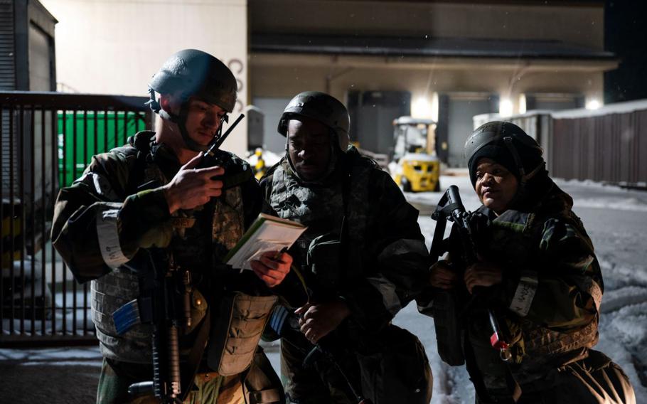 U.S. Air Force Staff Sgt. Tucker Looney, left, Senior Master Sgt. Christopher Johnson, center, and Staff Sgt. Tanya Muirhead, 51st Civil Engineer Squadron damage assessment repair team, report a hazard.