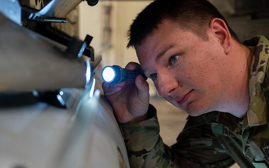 Senior Airman Casey Lang, 8th Maintenance Group slick low crew member, inspects routine maintenance functions at Kunsan Air Base, Republic of Korea, Sept. 7, 2023. Lang was selected as the Pride of the Pack by his leadership for the week of Sept. 4 - 8 for his outstanding performance executing his duties. (U.S. Air Force photo by Staff Sgt. Samuel Earick)