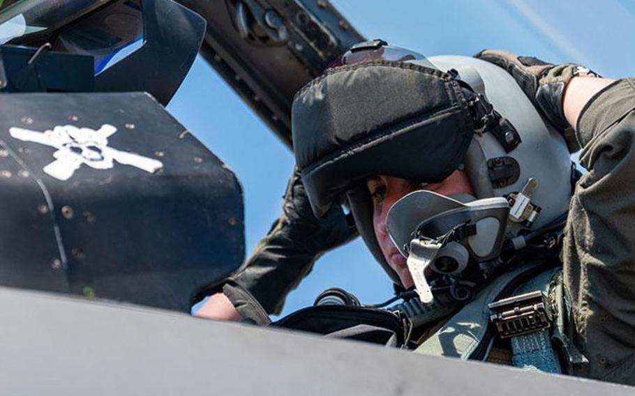 Capt. Megan Langas, 80th Fighter Squadron pilot, dons her helmet before take-off during a U.S.-Republic of Korea Buddy Squadron event at Jungwon Air Base, ROK, Aug. 8, 2023. The 80th FS worked in tandem with ROKAF’s 162nd FS to complete a series of training events during the week to reinforce partnership as well as share tactics, techniques and procedures. (U.S. Air Force photo by Staff Sgt. Samuel Earick)