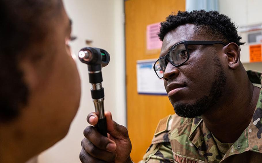 Staff Sgt. Emanuel Lookadoo, 8th Operations Medical Readiness Squadron independent duty medical technician, examines a patient's eye during a routine check-up at Kunsan Air Base, Republic of Korea Nov. 16, 2023. Lookadoo was the sole clinical subject matter expert for the day shift during Vigilant Defense 24 creating medical relevant injects and inspecting how the 8th Medical Group delivers its care. (U.S. Air Force photo by Staff Sgt. Samuel Earick)